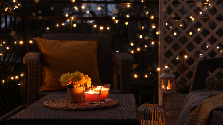 Outdoor seating surrounded by white Christmas lights