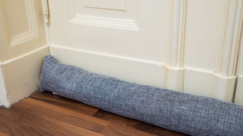 Draft excluder positioned at the bottom of a door