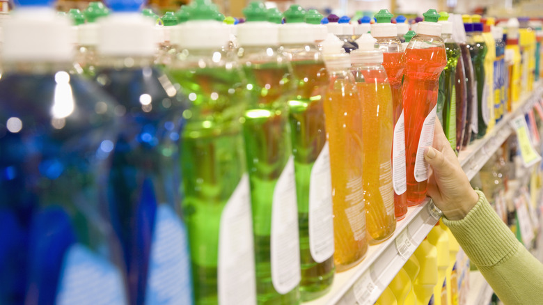 Colorful dish soaps displayed on supermarket shelf