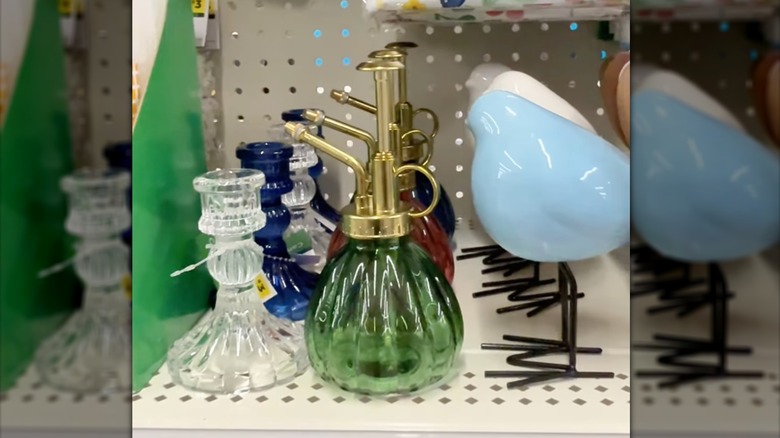 Dollar General glass plant misters in green, pink, and blue on shelf