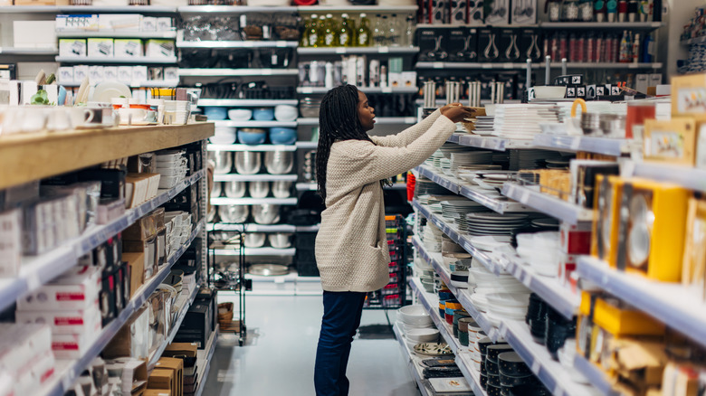 Woman looking through kitchenwares in a store