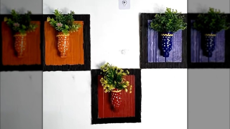 DIY wall art with plants made from plastic water bottles