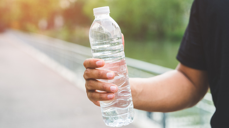 Man holding plastic water bottle