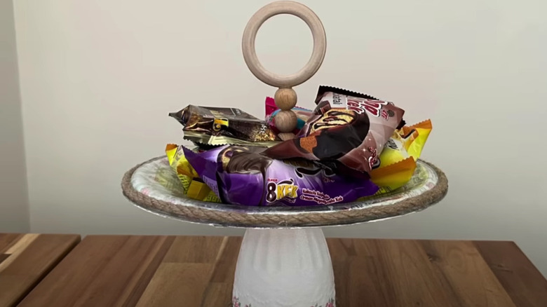 A service tray made from paper Mache pot lid and a broken tea cup.