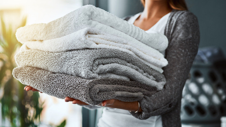 woman carrying bath towels