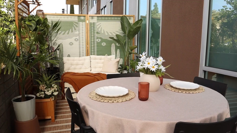 Patio with framed rugs as a privacy screen