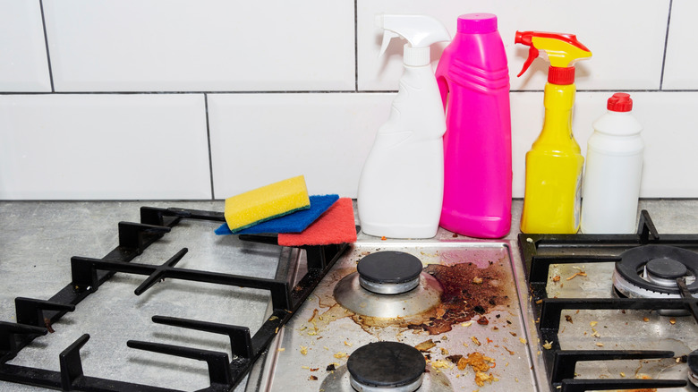 cleaning products on a dirty stovetop