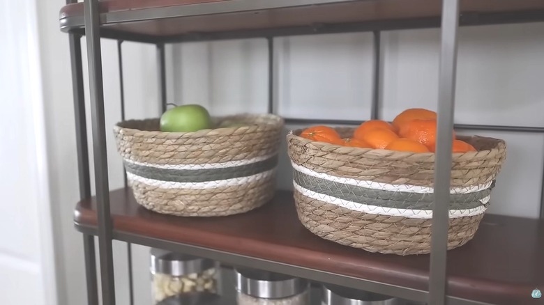 Dollar Tree woven baskets filled with green apples and clementines on shelf