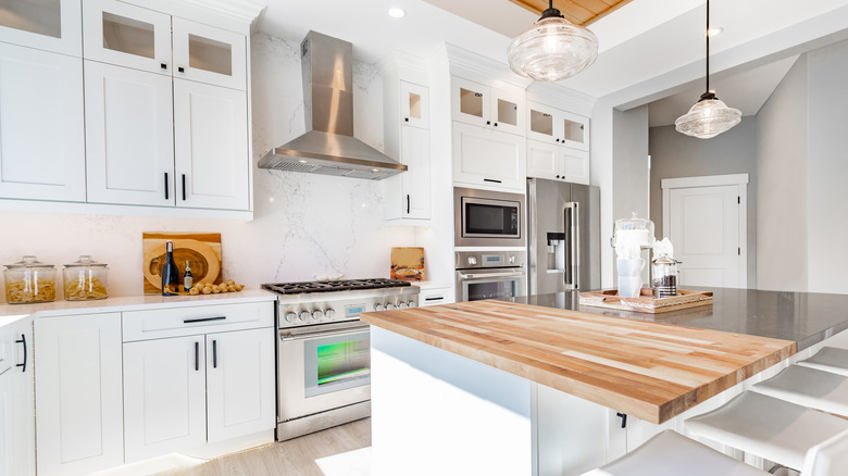 a farmhouse kitchen with stone perimeter countertops