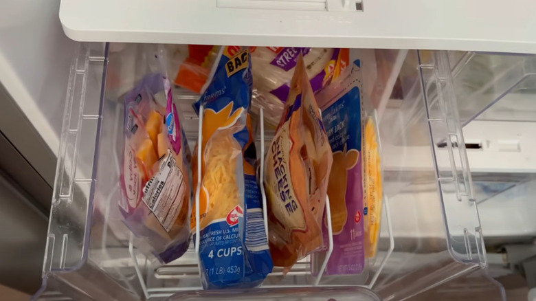 A dish drying rack being used for fridge organization.