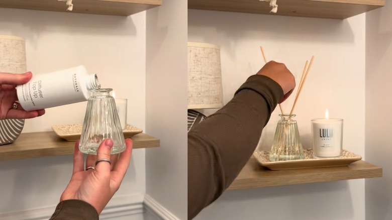 A person pouring diffuser fragrance into glass vase with diffuser sticks in bathroom