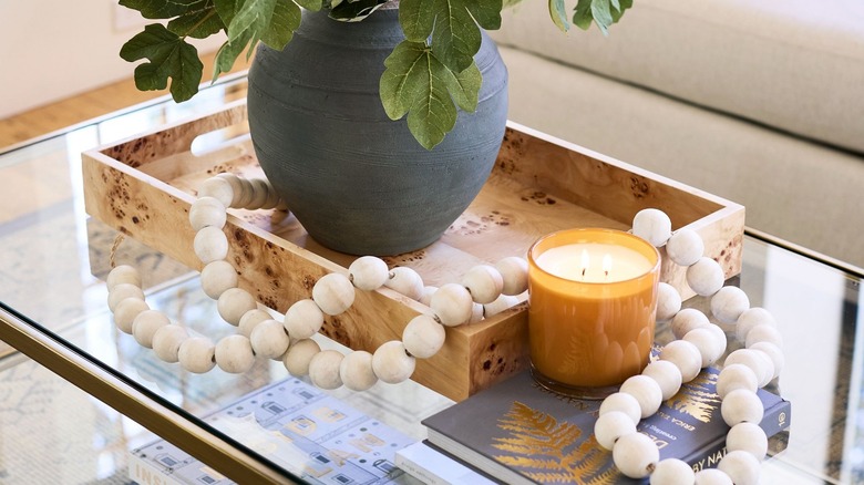 Wooden beads on glass table with coffee table decor