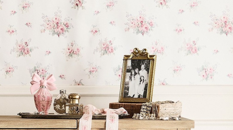 Elegant glam vanity top with gold bow picture frame and luxury products