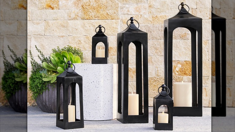 Assorted black industrial lanterns on luxury porch setting