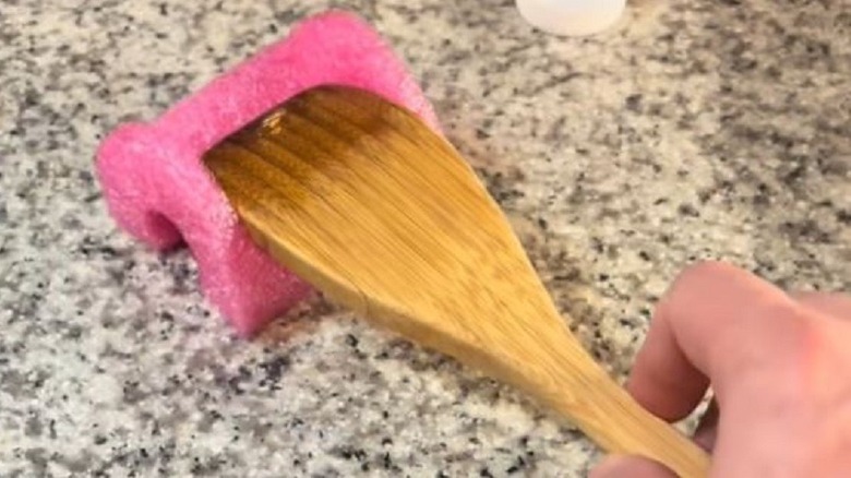 Wooden spoon on spoon rest made from pool noodle.