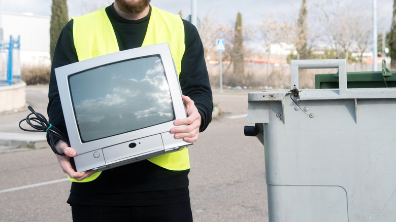 Recycle plant worker with old TV