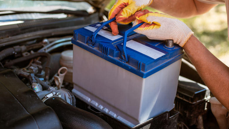 Man removing old car battery