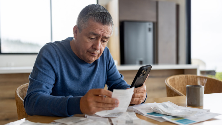 Older man looking over bank statements