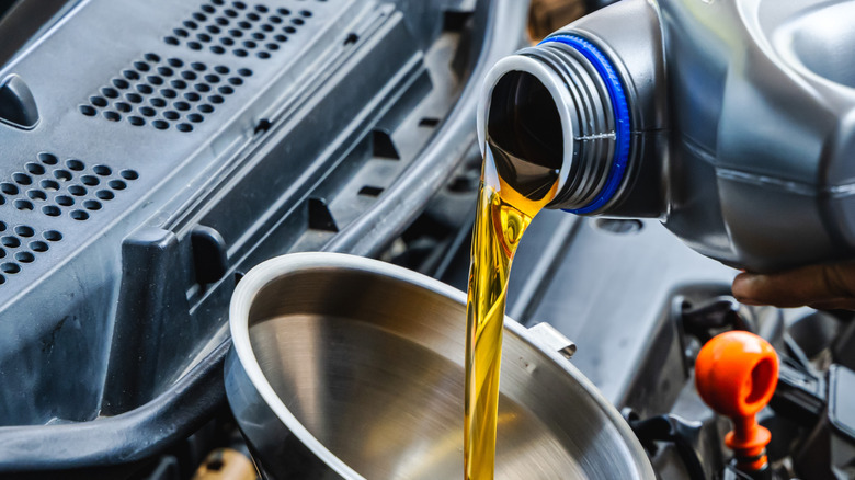 Motor oil being poured into an engine