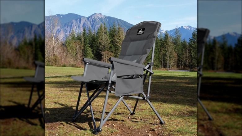 A folding padded camp chair sits in front of a mountain view