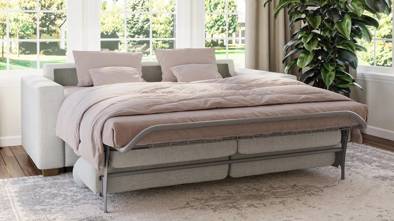 A large cream sleeper sofa