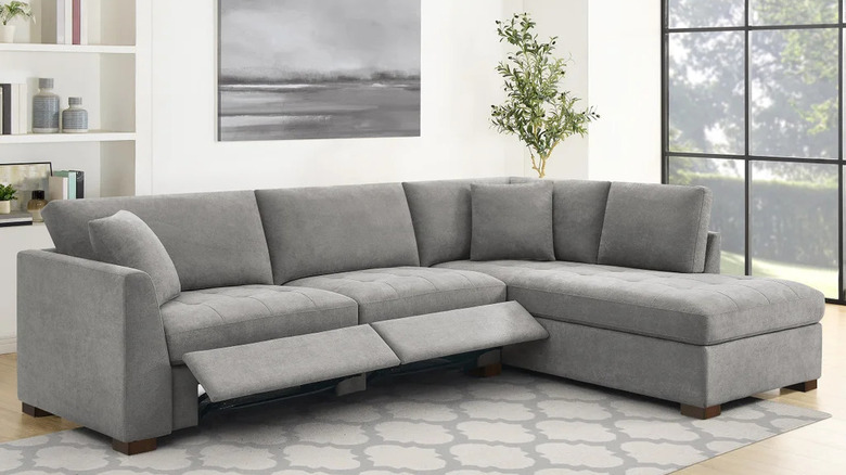 The footrest of a medium gray sectional is extended