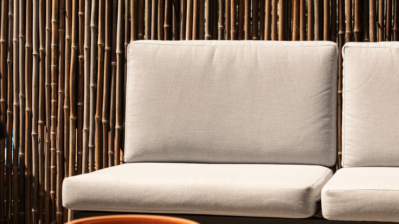 outdoor couch in front of bamboo privacy screen