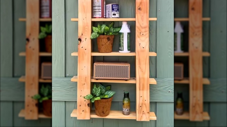 Repurposed wood boards as hanging outdoor shelf with garden items and home improvement products