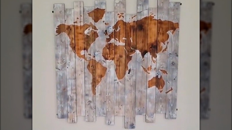 Gorgeous wood-burned world map on light staggered wooden boards