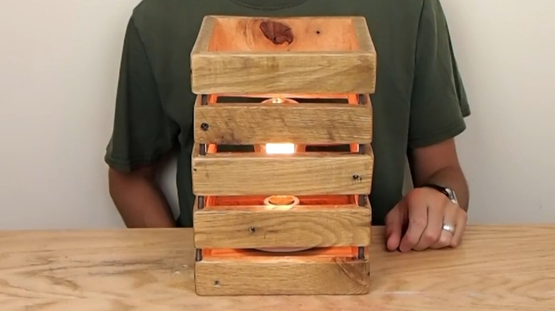 Homemade natural wood lamp with vintage-style bulb on wooden table