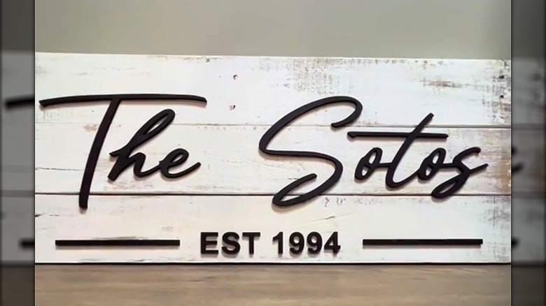 Homemade family name and dated sign made of reclaimed wood