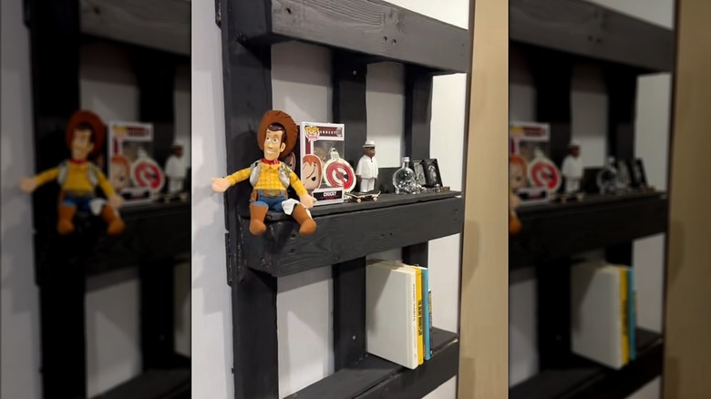 Popular childrens' toys on black DIY wall shelf with books