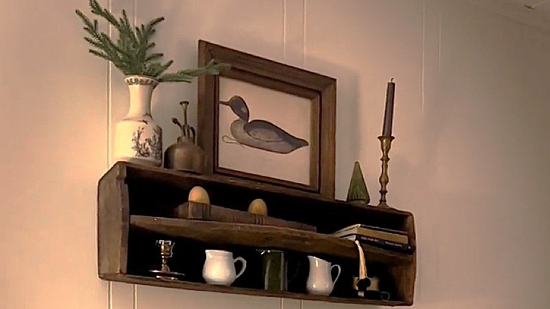 Wood toolbox mounted on wall and used as a shelving unit