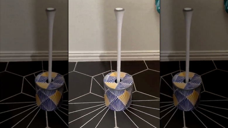 DIY bathroom plunger holder made from peel-and-stick paper and coffee canister