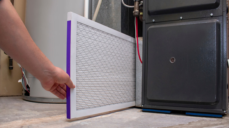 Tech swapping out furnace air filter