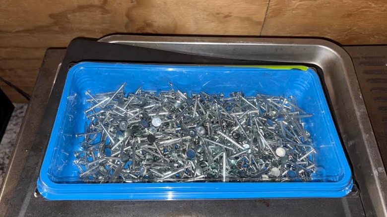 Hundreds of metal nails in enclosed Swiffer container in home garage