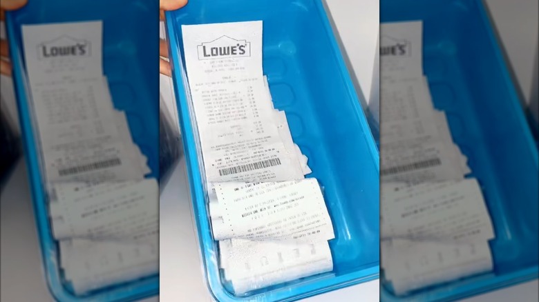 Multiple receipt piled in old swiffers mop container