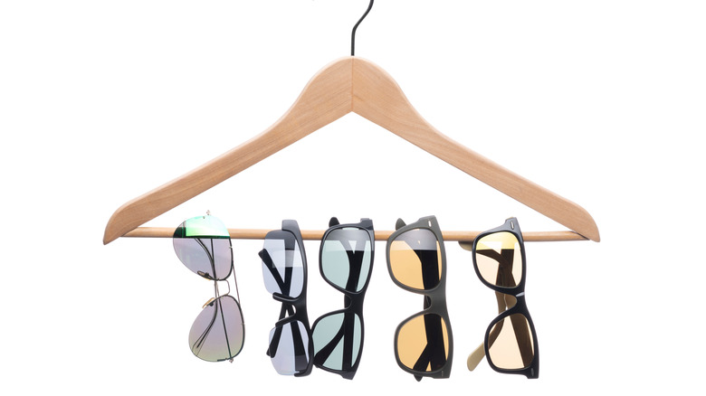 sunglasses looped over clothes hanger