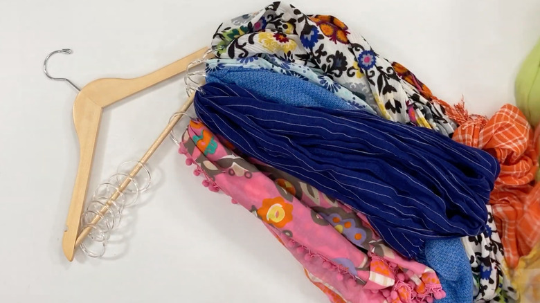 scarves on shower rings on wooden hanger