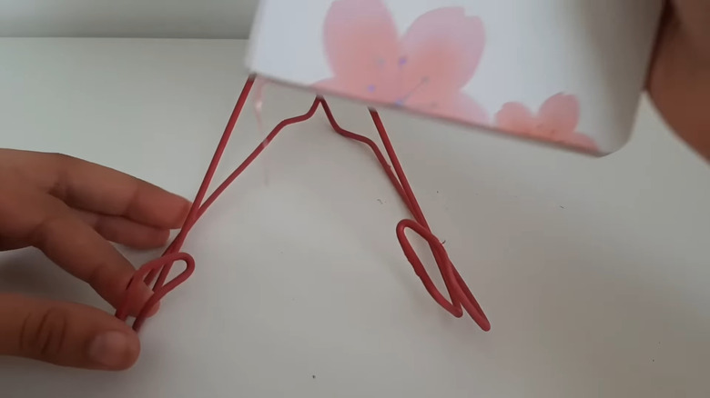 book being placed in wire book holder.