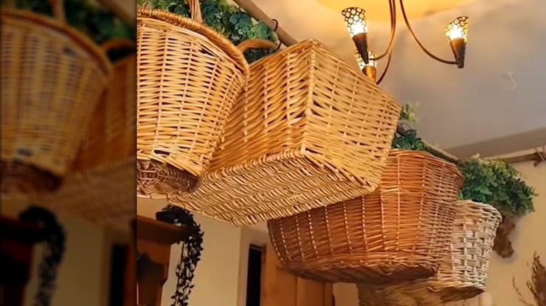 Hanging wicker baskets in classic farmhouse-style home with greenery and wood furniture