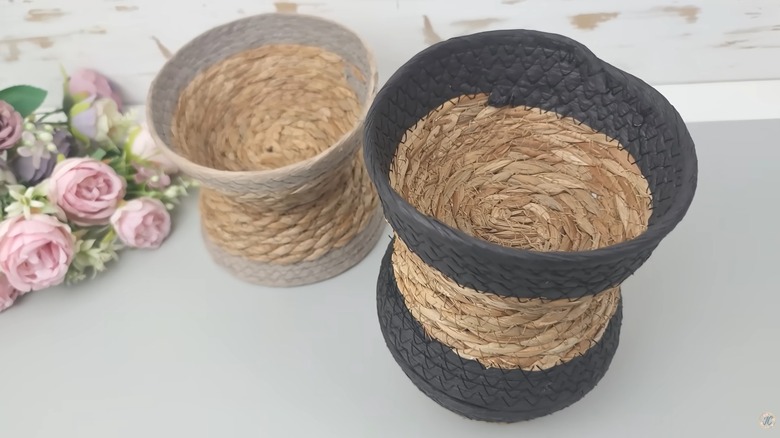 Dollar store woven baskets doubled up into vase shape on white table