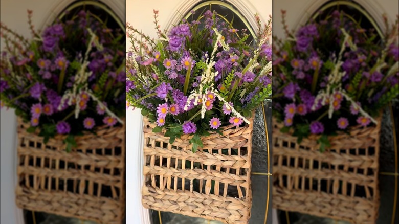 Hanging basket on front door with flower and leaf arrangement