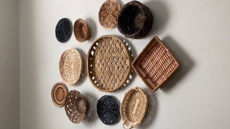 Assorted woven baskets arranged on basic white wall