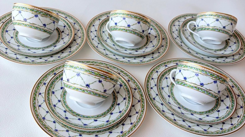 A collection of teacups, saucers, and plates in the Allee Royale pattern by Raynaud