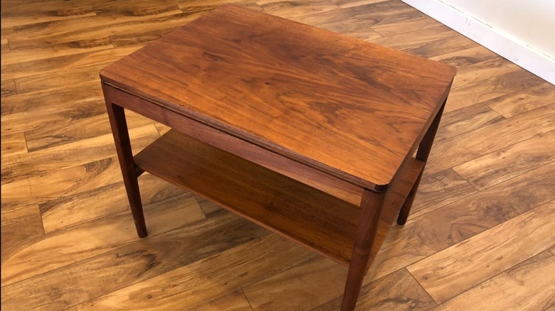 Vintage Drexel end table sitting on wood floors