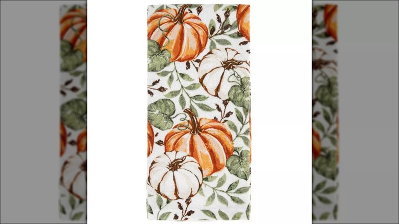 A pumpkin and leaf hand towel is shown in a detail shot