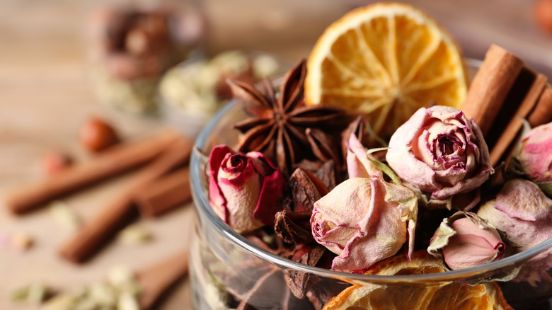 Potpourri bowl filled with cinnamon and spices, dried roses, and citrus
