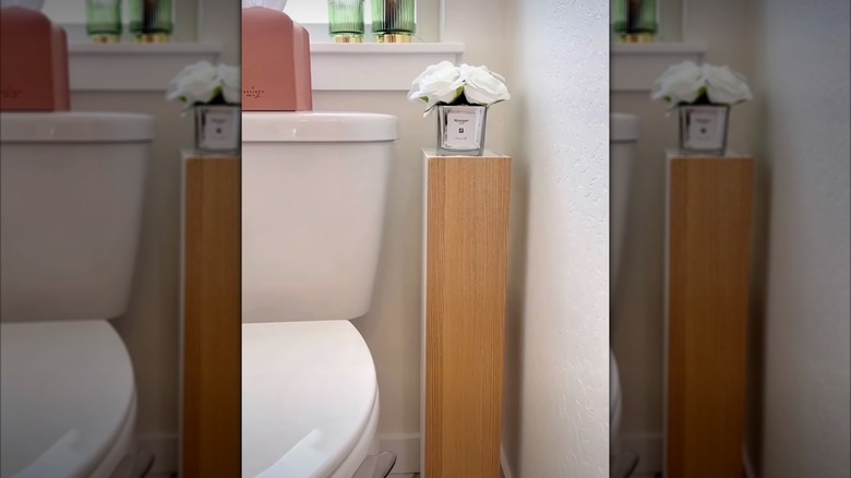 Narrow corner shelf next to toilet
