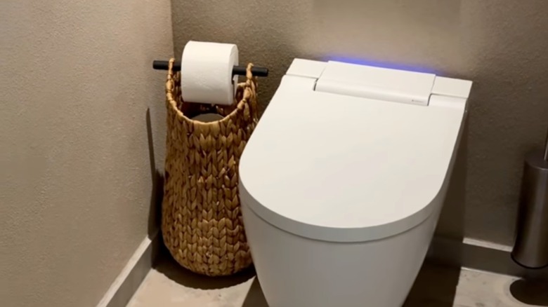 Tall floor basket next to toilet